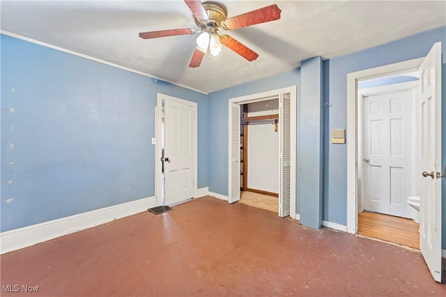 4723 Walnut St, Mantua, OH 44255 - unfurnished bedroom featuring concrete flooring, baseboards, a closet, and ceiling fan