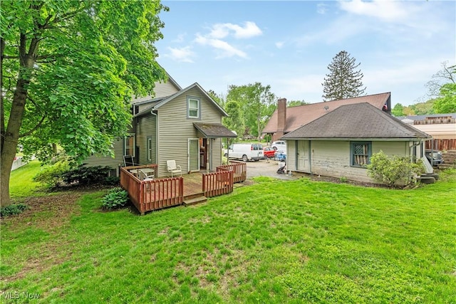 4723 Walnut St, Mantua, OH 44255 - rear view of house featuring a deck and a lawn