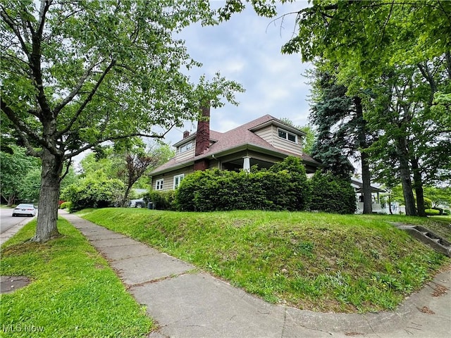 view of side of home with a chimney