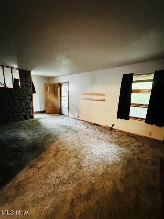 empty room with carpet and baseboards
