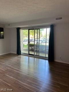 empty room featuring baseboards and wood finished floors