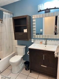 full bath featuring tile patterned flooring, toilet, vanity, shower / bath combo with shower curtain, and tasteful backsplash