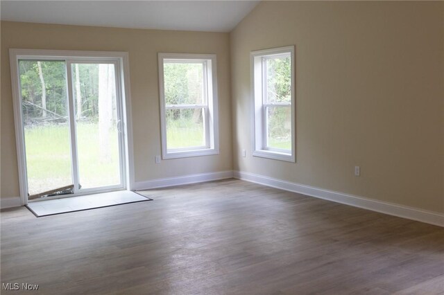246 W Hamilton St, Oberlin, OH 44074 - spare room with wood finished floors, baseboards, and vaulted ceiling