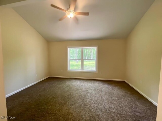 246 W Hamilton St, Oberlin, OH 44074 - unfurnished room with dark colored carpet, baseboards, vaulted ceiling, and ceiling fan
