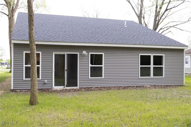 246 W Hamilton St, Oberlin, OH 44074 - rear view of property with a shingled roof and a lawn