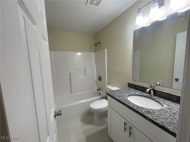 246 W Hamilton St, Oberlin, OH 44074 - bathroom with toilet, vanity, washtub / shower combination, and tile patterned floors