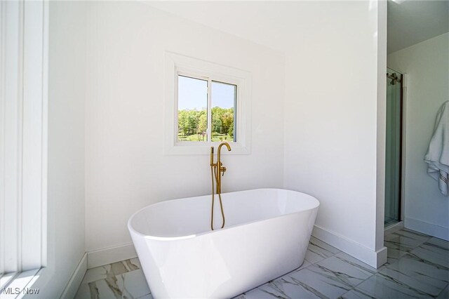 4043 Township Road 271, Killbuck, OH 44637 - bathroom featuring marble finish floors, baseboards, a soaking tub, and a shower stall