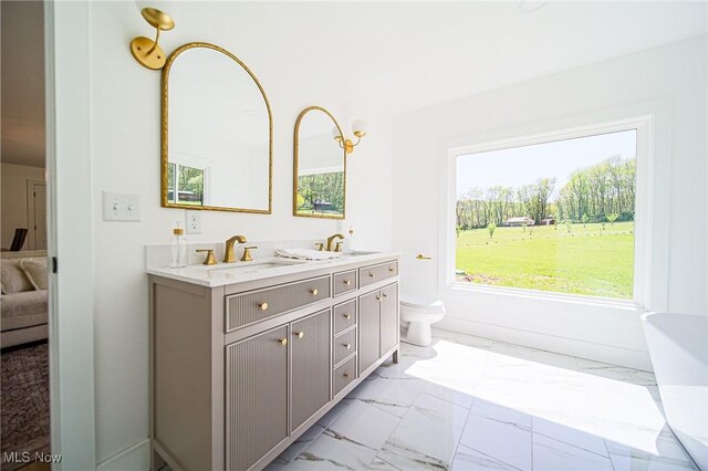 4043 Township Road 271, Killbuck, OH 44637 - full bathroom featuring marble look tile flooring, double vanity, toilet, and ensuite bath