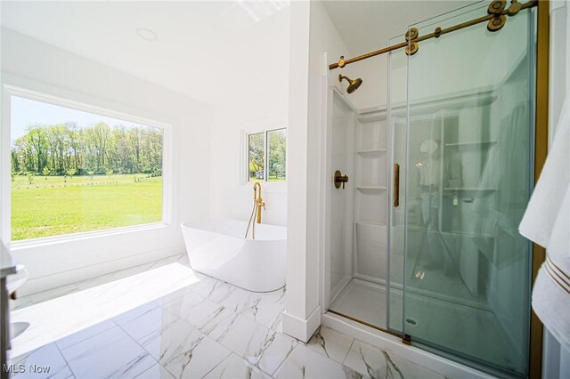 4043 Township Road 271, Killbuck, OH 44637 - bathroom with a stall shower, marble look tiles, a freestanding bath, and baseboards