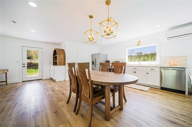 4043 Township Road 271, Killbuck, OH 44637 - dining room featuring a wall unit AC, a chandelier, light wood-style flooring, and recessed lighting