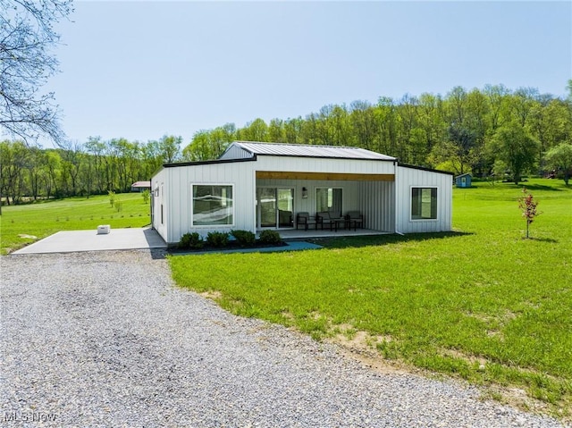 4043 Township Road 271, Killbuck, OH 44637 - rear view of property featuring a lawn, a patio area, and metal roof
