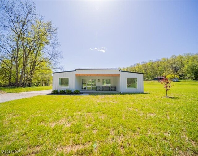 4043 Township Road 271, Killbuck, OH 44637 - back of house featuring a lawn