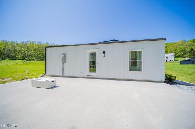 4043 Township Road 271, Killbuck, OH 44637 - back of property with a patio area and a lawn