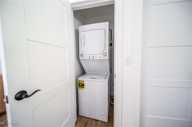 4043 Township Road 271, Killbuck, OH 44637 - laundry area featuring stacked washer and clothes dryer and light wood-style flooring
