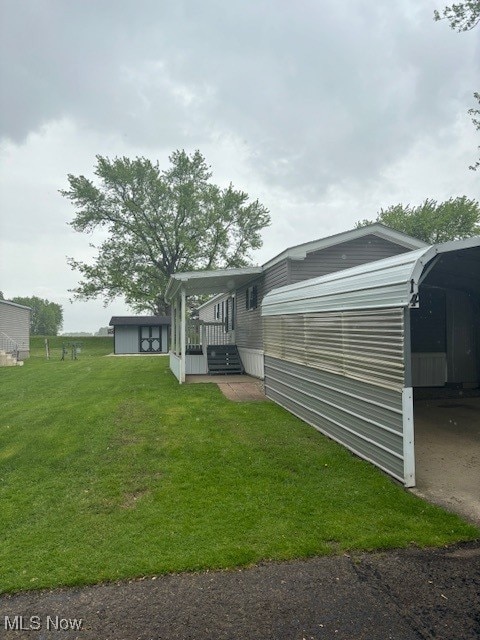 14 Carpenter Blvd, Marshallville, OH 44645 - back of house with a yard and an outbuilding