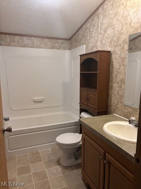 14 Carpenter Blvd, Marshallville, OH 44645 - full bath featuring wallpapered walls, vaulted ceiling, ornamental molding, vanity, and toilet