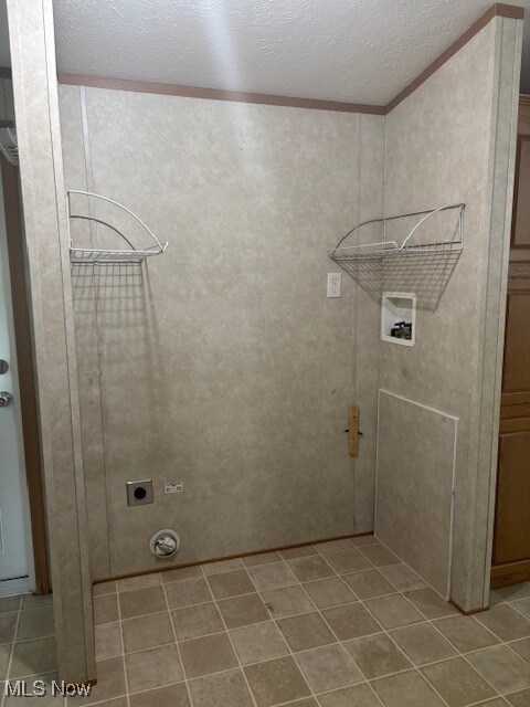 14 Carpenter Blvd, Marshallville, OH 44645 - washroom with washer hookup, electric dryer hookup, crown molding, tile patterned flooring, and a textured ceiling