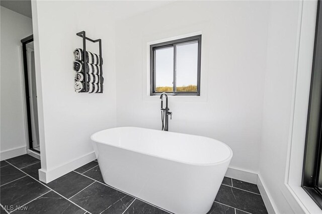 4059 Township Road 271, Killbuck, OH 44637 - bathroom featuring baseboards, a freestanding tub, and a shower stall