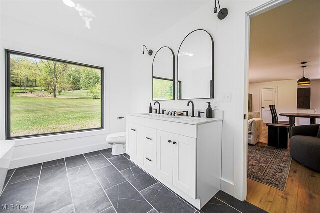 4059 Township Road 271, Killbuck, OH 44637 - bathroom featuring plenty of natural light, vanity, toilet, and baseboards