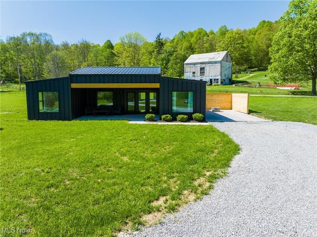 4059 Township Road 271, Killbuck, OH 44637 - surrounding community with a yard, gravel driveway, and a wooded view