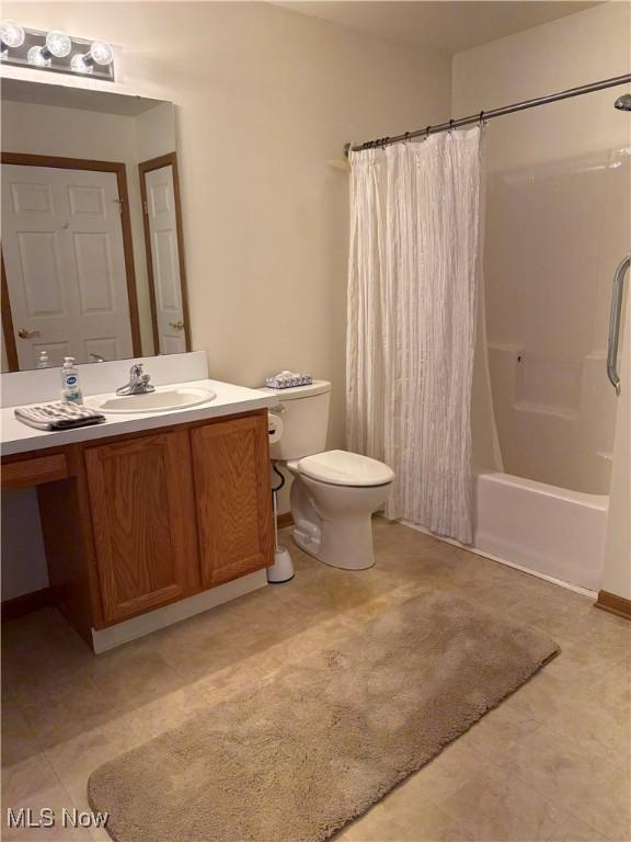 1932 S Lincoln Ave Unit 2, Salem, OH 44460 - full bath featuring vanity, toilet, shower / tub combo with curtain, and tile patterned flooring