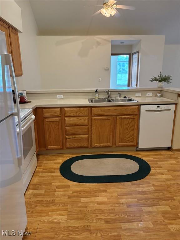 1932 S Lincoln Ave Unit 2, Salem, OH 44460 - kitchen with white appliances, a sink, light wood-style floors, and vaulted ceiling