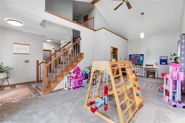 playroom featuring carpet flooring, a ceiling fan, baseboards, and high vaulted ceiling