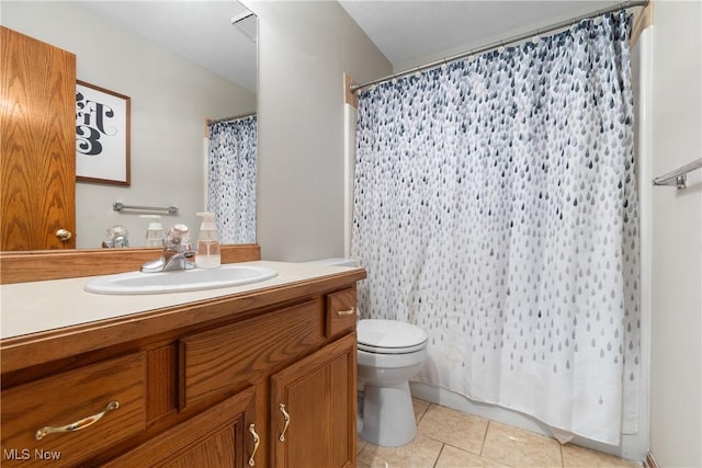 bathroom with tile patterned floors, toilet, vanity, and a shower with curtain