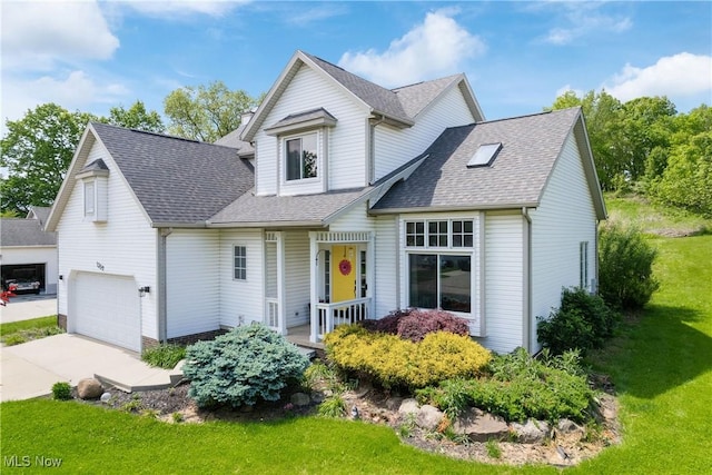 traditional-style house with a front lawn, concrete driveway, roof with shingles, an attached garage, and a porch