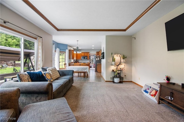 living room with a raised ceiling, a chandelier, light carpet, and baseboards