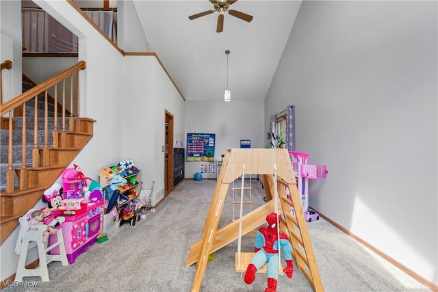 rec room with high vaulted ceiling, carpet, ceiling fan, and baseboards