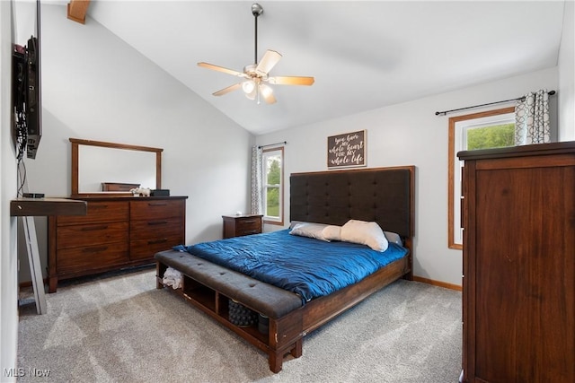 carpeted bedroom featuring vaulted ceiling, multiple windows, baseboards, and a ceiling fan