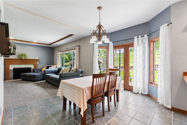 dining area featuring a chandelier, baseboards, a fireplace, tile patterned floors, and recessed lighting