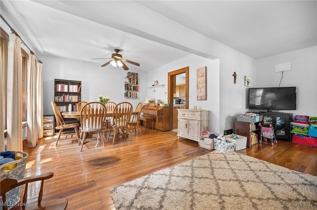 dining space with ceiling fan and wood finished floors