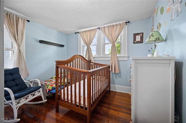 bedroom featuring wood-type flooring and baseboards