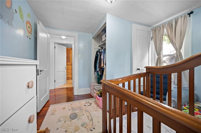 bedroom with wood finished floors and baseboards