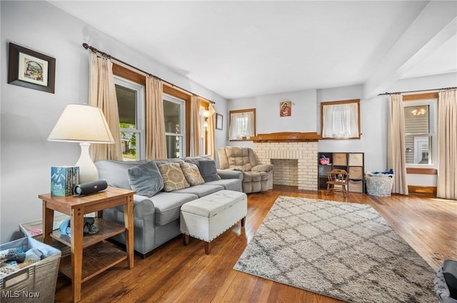 living room with hardwood / wood-style flooring and a fireplace