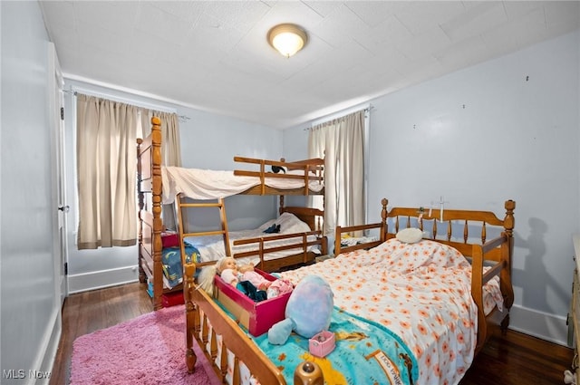 bedroom with wood finished floors and baseboards