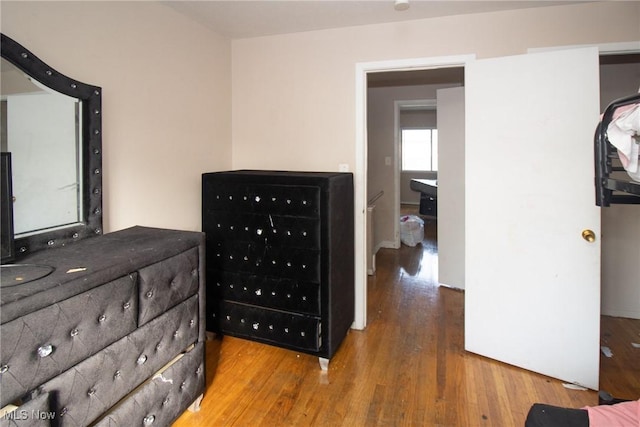 bedroom with wood finished floors and mail area