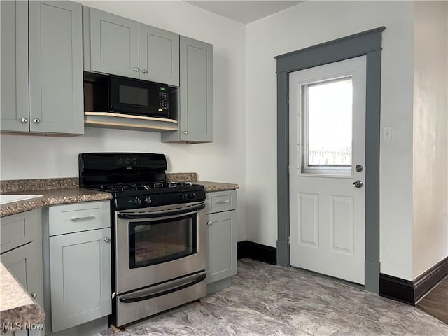 3039 W St, Weirton, WV 26062 - kitchen featuring black microwave, stainless steel range with gas stovetop, baseboards, and gray cabinets