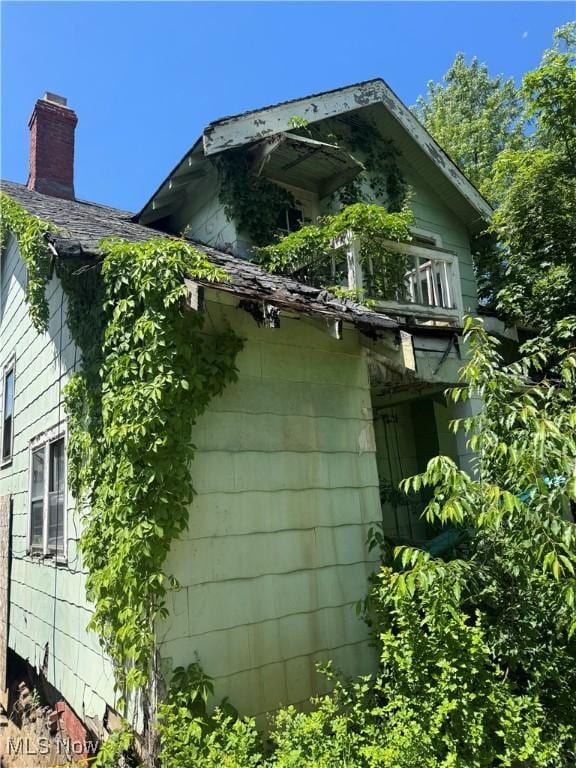 view of home's exterior featuring a chimney