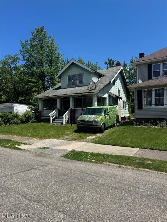 bungalow with a porch and a front yard