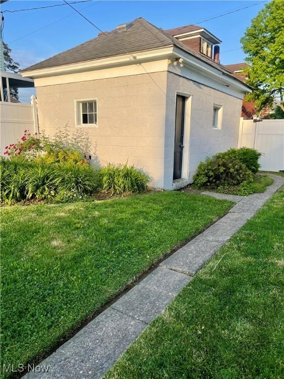 1726 Covert St, Parkersburg, WV 26101 - view of property exterior featuring concrete block siding and a shingled roof