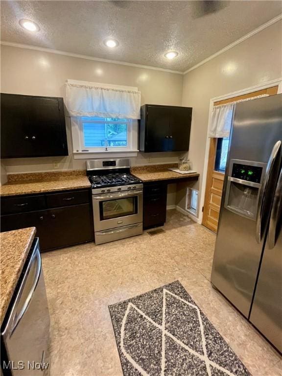 1726 Covert St, Parkersburg, WV 26101 - kitchen featuring appliances with stainless steel finishes, a textured ceiling, crown molding, dark cabinetry, and light countertops