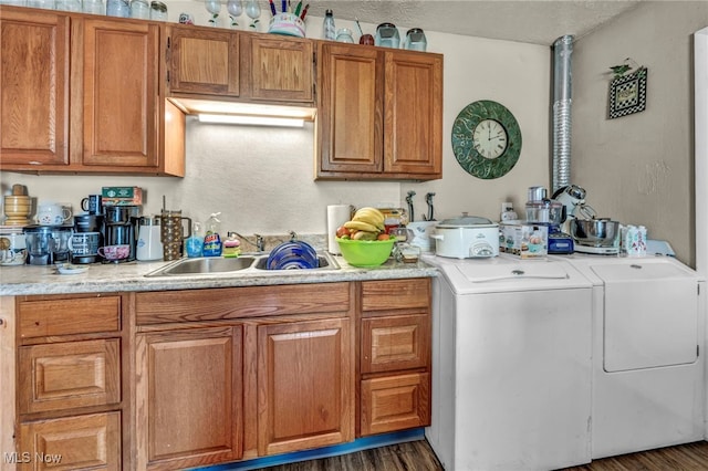 2212 Randall St, Lorain, OH 44052 - kitchen featuring a sink, light countertops, brown cabinetry, separate washer and dryer, and dark wood finished floors