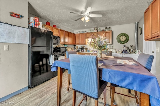 2212 Randall St, Lorain, OH 44052 - dining space featuring ceiling fan, light wood-style flooring, a textured ceiling, and baseboards
