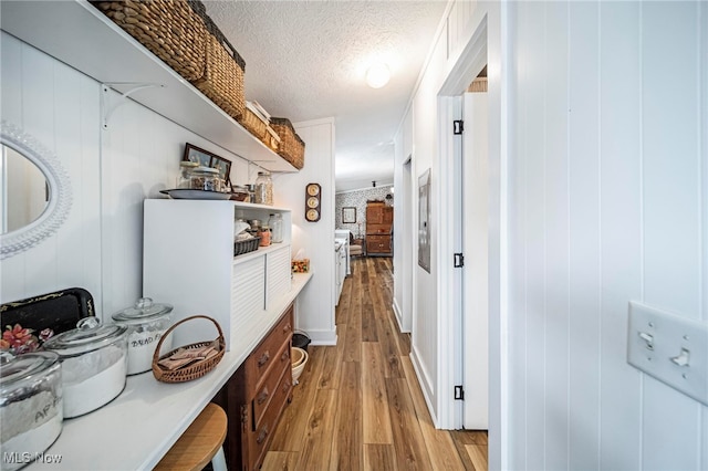 7214 Ridge Ave, Conneaut, OH 44030 - hallway featuring light wood finished floors and a textured ceiling
