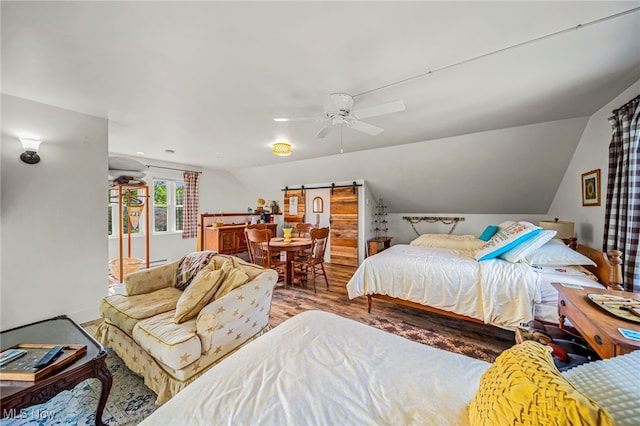7214 Ridge Ave, Conneaut, OH 44030 - bedroom featuring wood finished floors, a barn door, a ceiling fan, and lofted ceiling