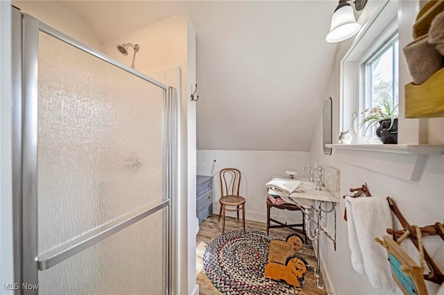 7214 Ridge Ave, Conneaut, OH 44030 - full bathroom featuring vaulted ceiling, a shower stall, and wood finished floors