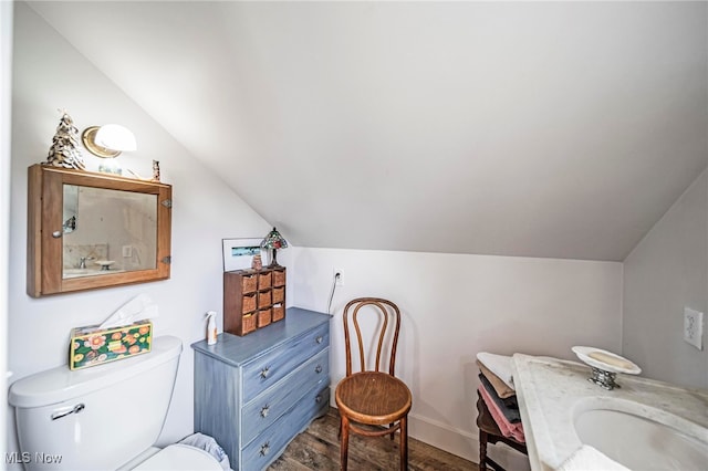 7214 Ridge Ave, Conneaut, OH 44030 - bathroom with lofted ceiling, wood finished floors, baseboards, toilet, and vanity